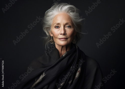 Portrait of an elegant older Caucasian woman with a black backdrop