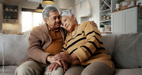 Senior, couple and hug for empathy on sofa with support, grief and comfort in living room of house. Old people, man and woman with love and embrace for security, compassion and sympathy on couch photo