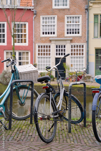 Obraz na płótnie Picturesque Netherlands. Bicycles parked alongside a channel on beautiful old buildings background. w salonie