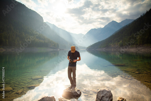 person on a lake with mountains 