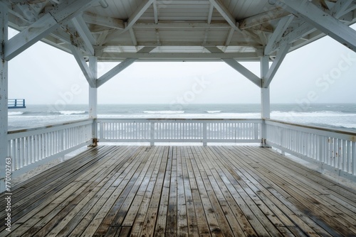 A wooden gazebo overlooking the ocean, captured on a cloudy and moody day