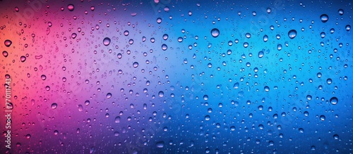 Water drops on glass with pink and blue gradient. Abstract background.