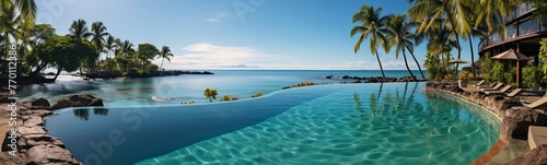 Panoramic view of beautiful tropical beach with palm trees and swimming pool
