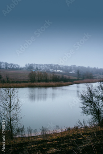 Fogy mystery blue lake at morning . Water reflaction. Lake and forest . Winter fog . Landscape with fog 