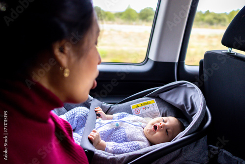 Mom and her baby singing in a car