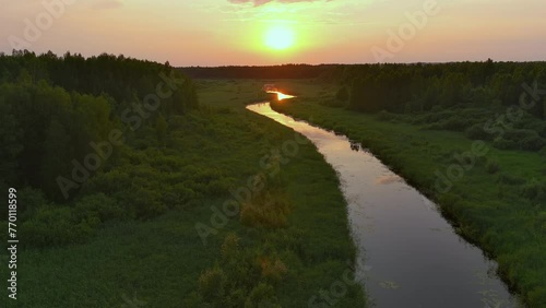 Amazing drone shot of the Vohandu river in Estonia. Beautiful Estonian nature and landscape. Idyllic sunset in the background. Camera slowly moving sideways. Geology shot. photo