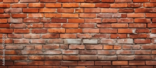 Detailed view of a solid brick wall displaying numerous individual bricks in varying shades and textures