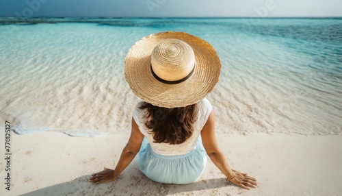 Woman in straw hat sitting on beach view from above. Summer vacation at Maldives