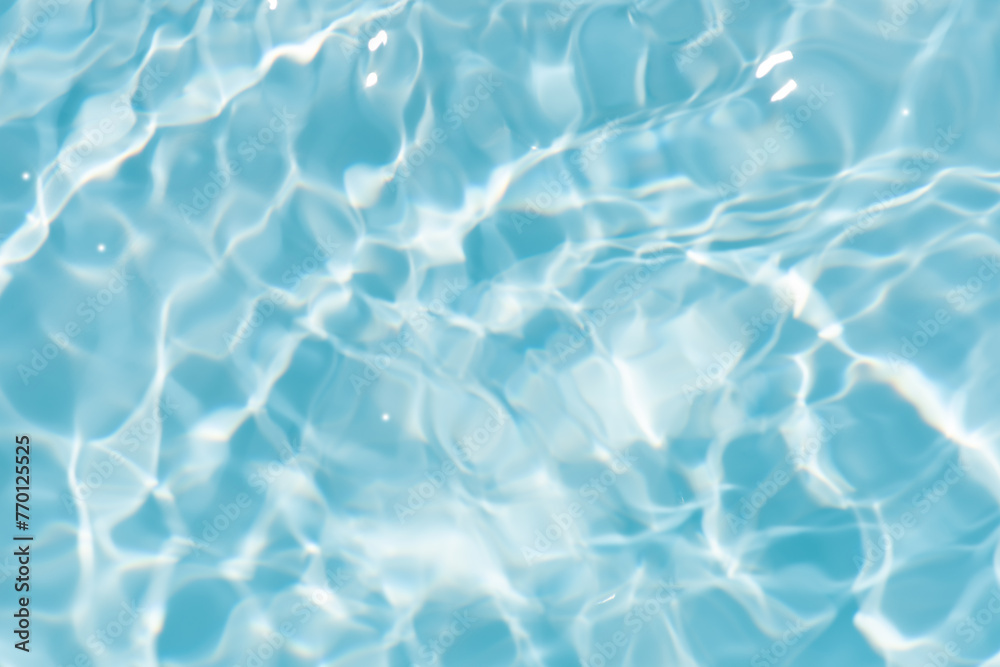 Bluewater waves on the surface ripples blurred. Defocus blurred transparent blue colored clear calm water surface texture with splash and bubbles. Water waves with shining pattern texture background. Bluewater waves on the surface ripples blurred. Defocus blurred transparent blue colored clear calm water surface texture with splash and bubbles. Water waves with shining pattern texture background.