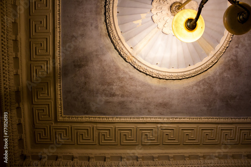 Photos Old chandelier on the ceiling with stucco molding in a classic style