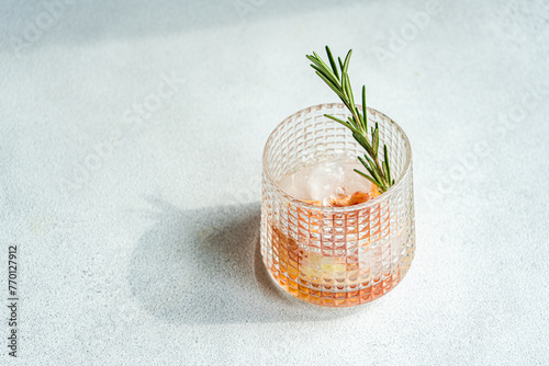 Top view of elegantly presented vodka tonic with a twist of grapefruit and a sprig of rosemary, symbolizing sophisticated refreshment photo