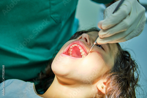 An engaged dentist conducts a routine dental check-up on a young patient, showcasing the standard of pediatric oral care