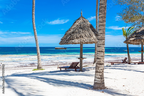 Chair and green trees on a white sand beach. Watamu, Kenya - Africa.