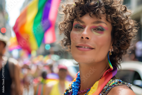 Transgender person at gay pride parade, copy space of a woman in makeup with lgbt flag people celebrating in the street