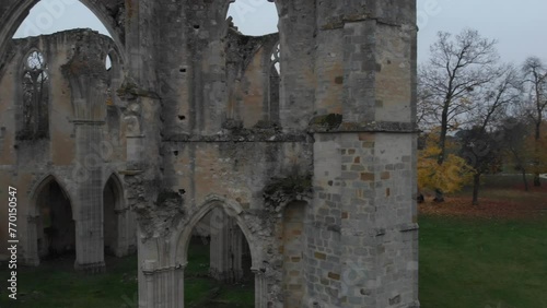 Ruins of Abbaye Notre-Dame du Lys in France on a gray autumn day and colorful autumn leaves