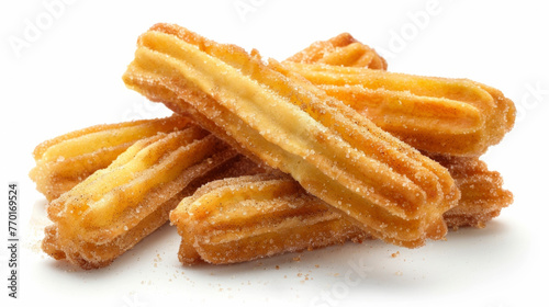 A collection of churros stacked on a plain white tabletop.