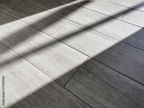 Slika na platnu The texture is a pattern of porcelain stoneware tiles on a gray floor with a woo
