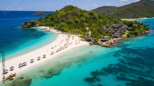 Aerial view of beautiful tropical island with white sand, turquoise water and blue sky.