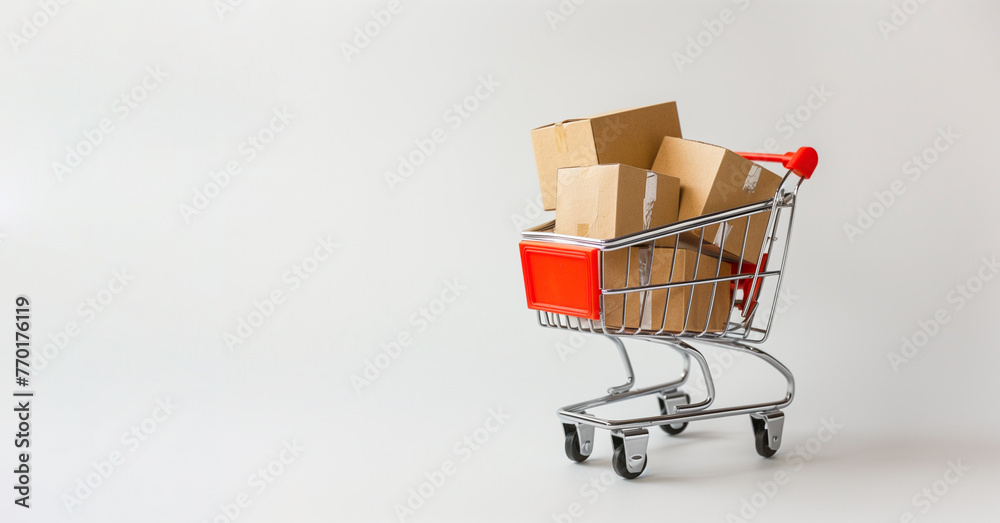 Mini Shopping Cart Full of Boxes on White Background With Copy Space