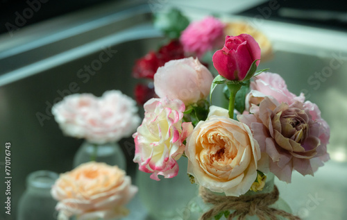 Various roses arranged in glass vase. Roses are best known as ornamental plants grown for their flowers in the garden and sometimes indoors.