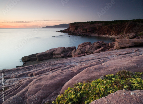 beach and rocks, Twilight, Porto Ferro, Sassari, Sardinia, Italy. Long exposure and Motion blur on waves