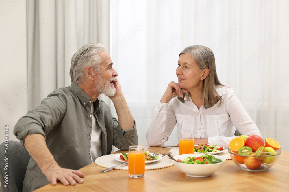 Happy senior couple having dinner at home Happy senior couple having dinner at home