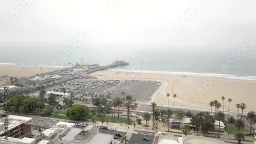 Panning Drone Shot of Santa Monica Pier with the Pacific Ocean and Santa Monica, California in the Background on a nice day photo