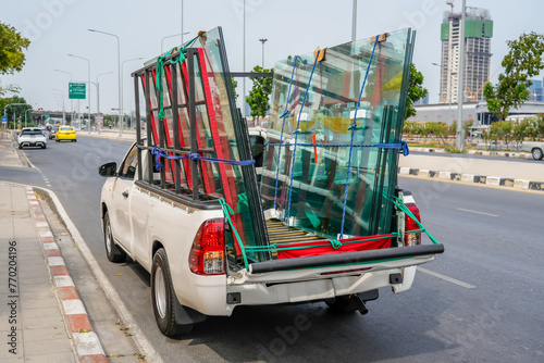 Glass sheets for a showcase window loaded into the back of a truck, for transportation of delivery and installation on site, delivery of fragile cargo around the city
