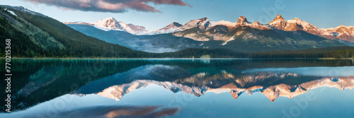 Mountains towering over a serene lake (ID: 770215368)