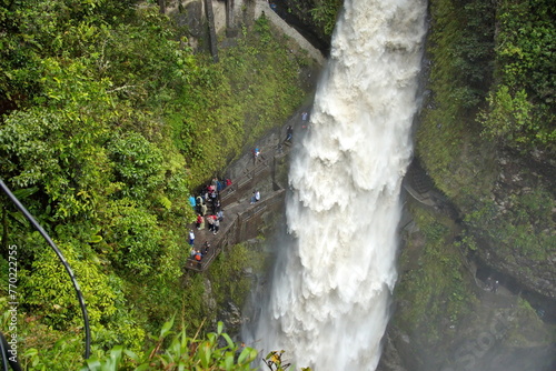 Tourists on a trail behind the Pailon del Diablo waterfall in Banos, Ecuador photo