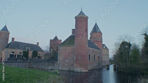 A beautiful cinematic walkthrough scenery of europeaan authentic castle mansion estate building with dutch style architecture and water photo