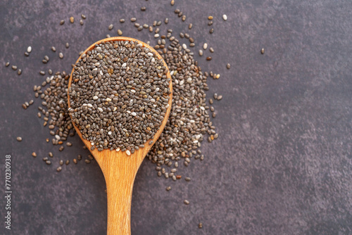 Chia seeds (Salvia hispanica) Salba chia edible seeds in wooden spoon. photo