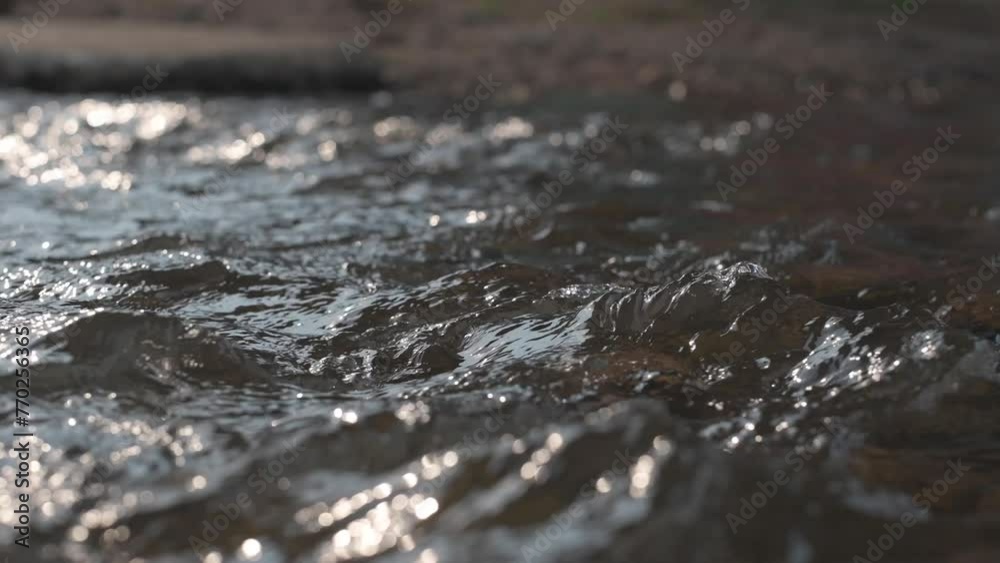 closeup of the surface of a little stream with reflecting water,Super slow motion of dark water waves in detail. closeup of the surface of a little stream with reflecting water,Super slow motion of dark water waves in detail.