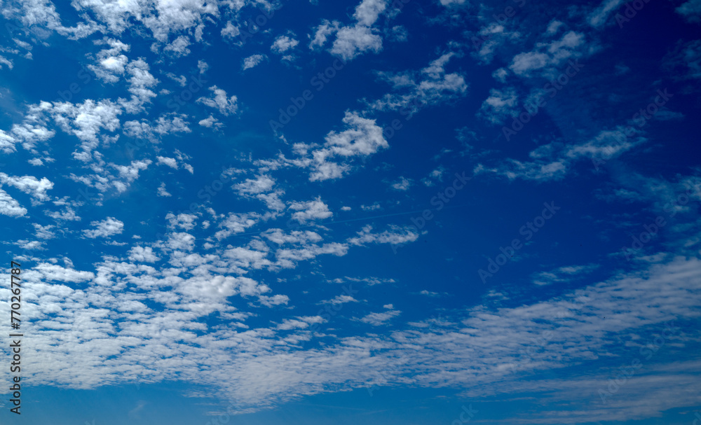 Spring blue sky cloud gradient background. Cloudy sky. Vivid cyan blue landscape in environment day horizon skyline view. White clouds on soft sky background. White cloudy sky. Spring blue sky cloud gradient background. Cloudy sky. Vivid cyan blue landscape in environment day horizon skyline view. White clouds on soft sky background. White cloudy sky.
