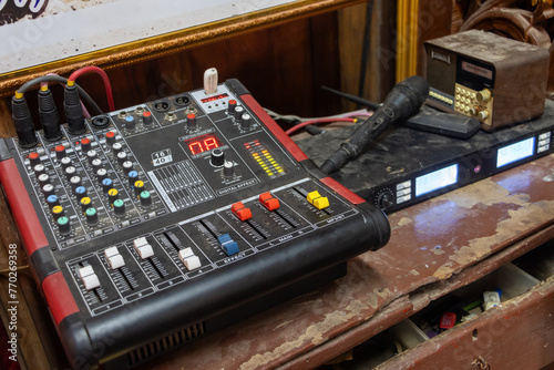 Professional sound mixer on a table inside a buddhist temple, Thailand