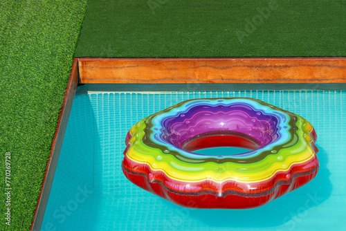 Colorful inflatable ring on the surface of the swimming pool