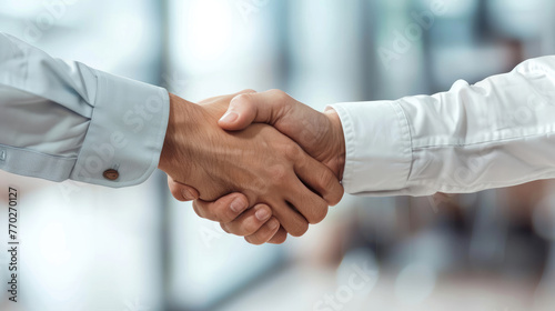 Photo of Business Associates Shaking Hands in Office Environment