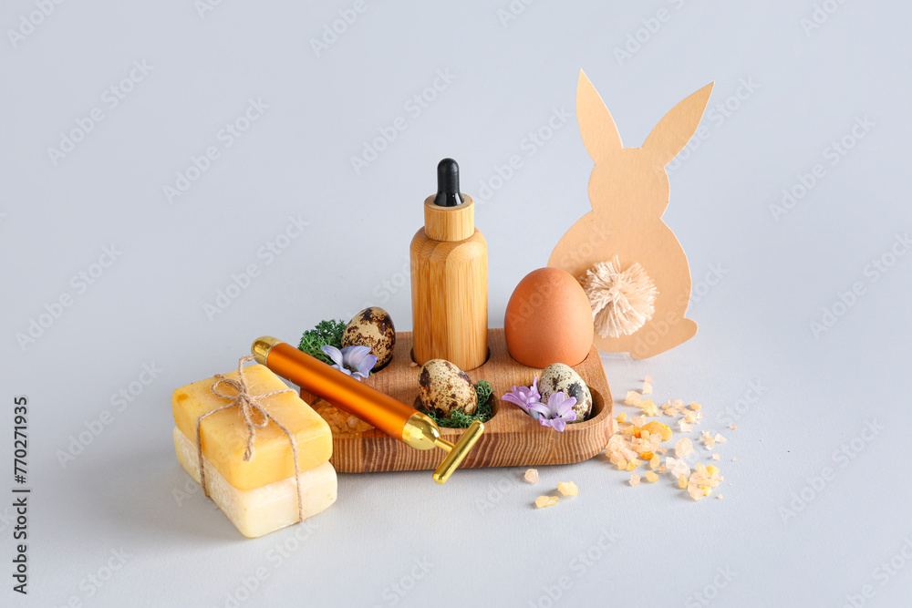 Naklejka premium Composition with spa supplies and Easter decor on grey background