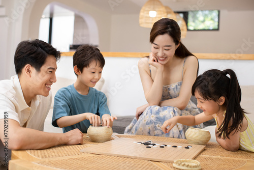 Happy family playing the game of go