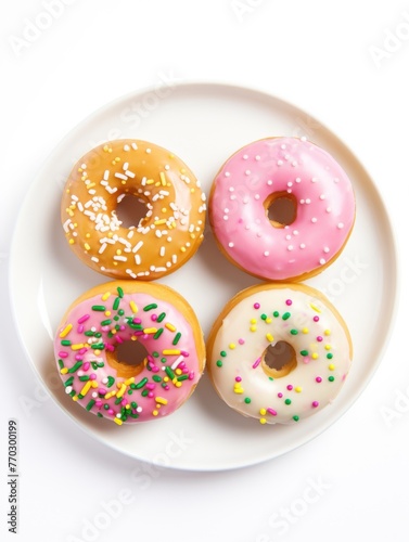 Four donuts with sprinkles on top of a white plate. The donuts are of different colors and sizes, and they are arranged in a neat row. Concept of indulgence and enjoyment