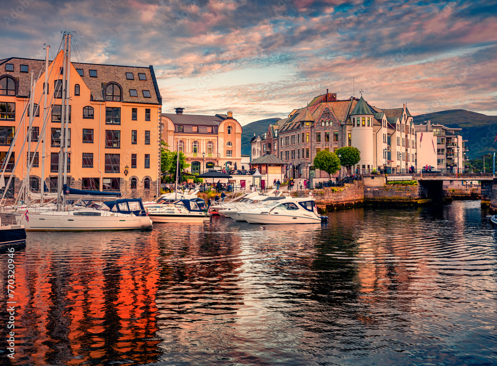 Spectacular summer sunset on Alesund port, town on the west coast of Norway, at the entrance to the Geirangerfjord. Wonderful morning cityscape. Traveling concept background..