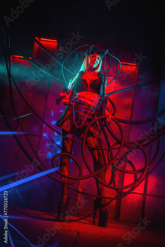Beautiful futuristic girl posing in the neon lights. Cyberpunk concept.