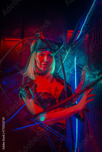 Beautiful futuristic girl posing in the neon lights. Cyberpunk concept.