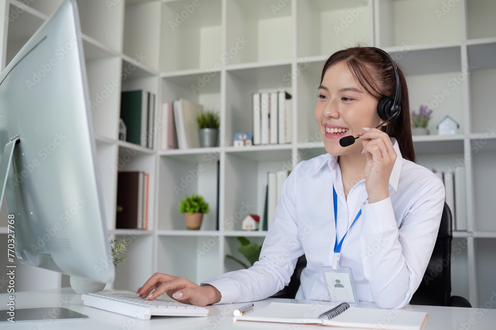 Call center agents wear headphones to talk to customers. Provide consultation via online channels on laptops