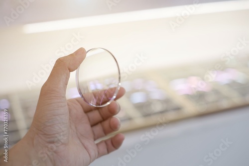 hand with eyeglass lenses 