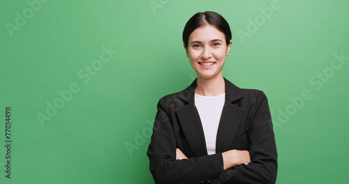 Portrait of attractive businesswoman in a suit. Isolated on green background in studio.
