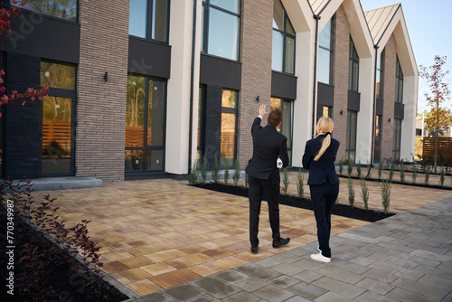 Back view picture of client and realtor walking near buildings © Svitlana