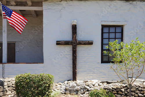 US flag and Christian cross side by side on a historic church