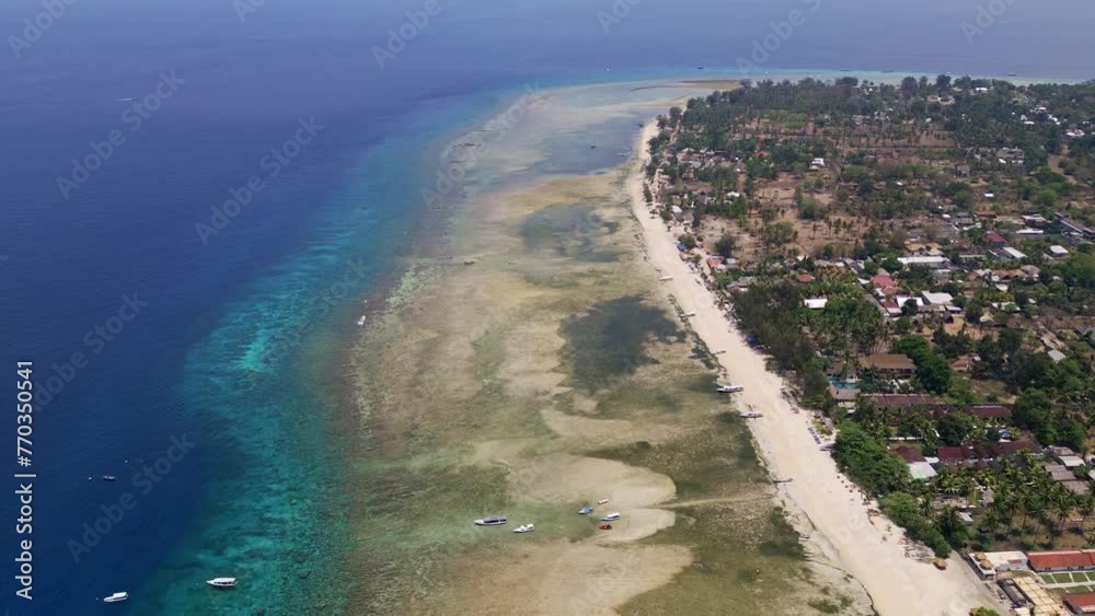 Drone flight over a fringing tropical coral reef on a tropical island Drone flight over a fringing tropical coral reef on a tropical island