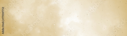 Raindrops, water dripping, rain on a glass pane, rainy weather with clouds, beige and brown texture	